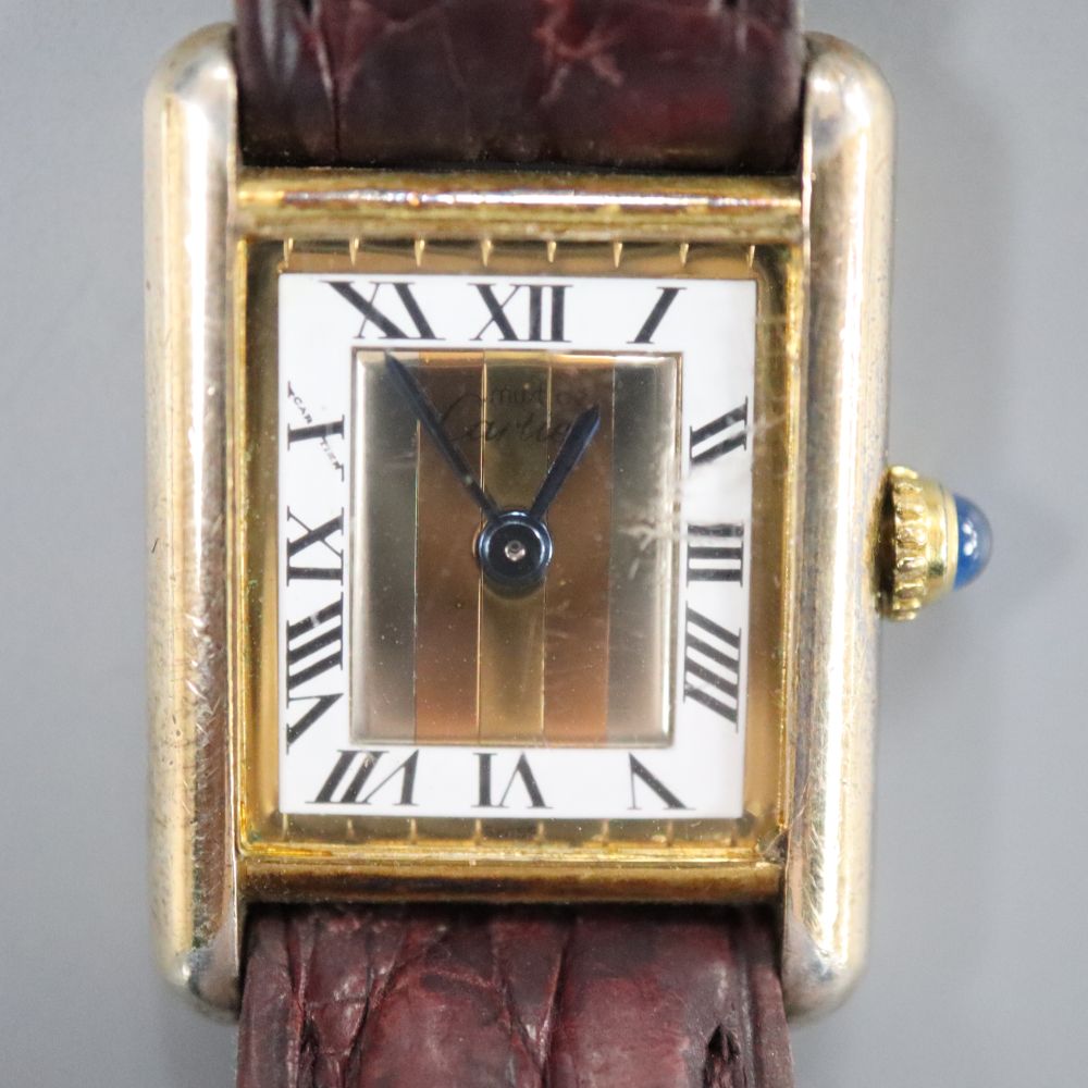 A ladys 925 gilt Cartier Vermeil Tank quartz rectangular wrist watch, with three colour Roman dial, on Cartier leather strap,